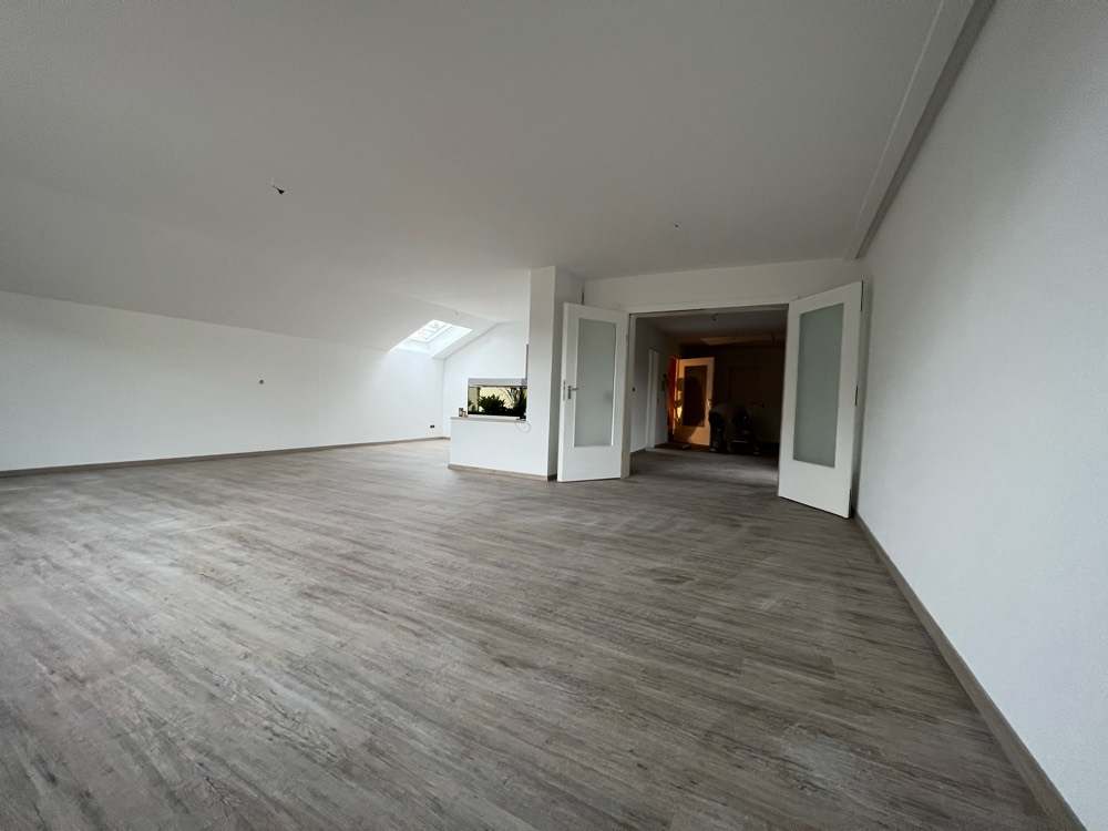 Derselbe Dachgeschossraum fertig saniert, mit Vinylboden und neuer Flügeltür